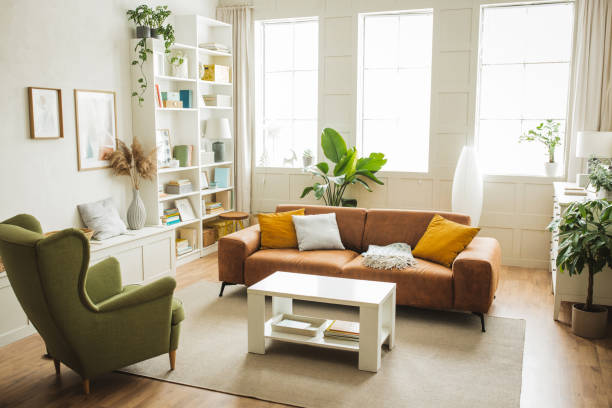 Sofa and armchair in living room. Interior of simple home. Furniture is arranged in sitting area.